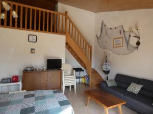 a living room with a couch and a staircase at Notre-Dame-de-Monts (85) - Maison de vacances 61m² environ - 8 personnes - FR-1-540-164 in Notre-Dame-de-Monts