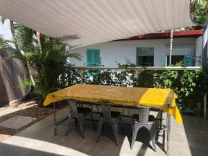 a table with a yellow table cloth on a patio at The Hideway in Noumea