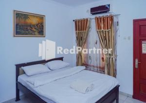 a bedroom with a bed in a room at MS Hotel Pangandaran Mitra RedDoorz in Pangandaran