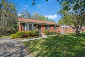 a brick house with a lawn in front of it at 3 Mi to City & Pet Friendly & Quiet Neighborhood in Charlotte