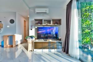 a living room with a large tv and a large window at A503-Penthouse Amazing View 2brs3bedsAo Nang Beach Center in Ao Nang Beach