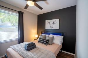 a bedroom with a bed with a cow on the wall at 3 Mi to City & Pet Friendly & Quiet Neighborhood in Charlotte