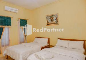 Ένα ή περισσότερα κρεβάτια σε δωμάτιο στο MS Hotel Pangandaran Mitra RedDoorz