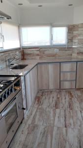 an empty kitchen with a stove and a sink at Depto para 4 personas in San Antonio Oeste