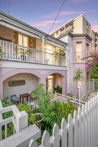 a house with a white fence in front of it at Accommodation in Fremantle in Fremantle