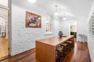 a kitchen with a wooden island in a white wall at Accommodation in Fremantle in Fremantle