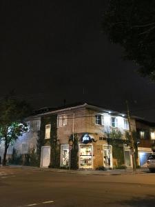 a brick building with lights in front of it at Prédio Histórico na Rio Branco in Caxias do Sul