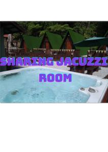 a picture of a swimming pool in front of a house at Rustcamps Glamping Resort in Genting Highlands