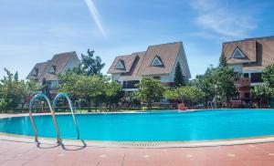 a swimming pool with a slide in front of some houses at Lotus Vung Tau Resort & Spa in Vung Tau