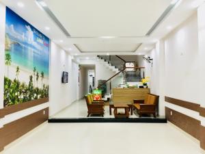 a lobby of a hotel with chairs and a table at DANA BEACH Motel in Danang