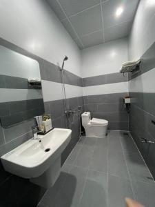 a bathroom with a sink and a toilet at Nine Hotel Gia Lai in Pleiku