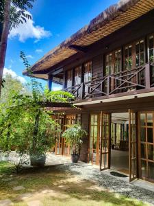 an exterior view of a house with sliding glass doors at The Red Hen Homestead in Batangas City