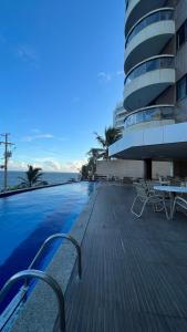 a swimming pool in front of a building at Lindo vista mar na Praia do Buracão - Rio Vermelho in Salvador