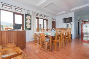 a kitchen and dining room with a table and chairs at Erika Homestay in Lembang
