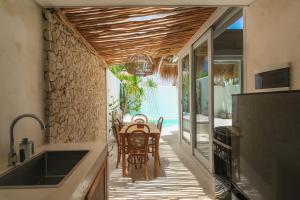 a kitchen and dining room with a table and chairs at Amaka Villas in Uluwatu