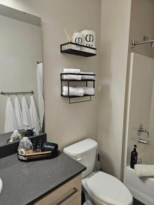 a bathroom with a white toilet and a sink at Chic Queen Anne Retreat in Seattle