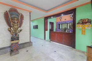 a building with a statue in a hallway at Urbanview Hotel Taman Suci Denpasar Bali in Denpasar