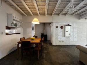 a dining room with a wooden table and chairs at Kasbah inn in La Cumbre