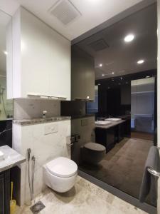 a large bathroom with a toilet and a sink at The Platinum KLCC in Kuala Lumpur