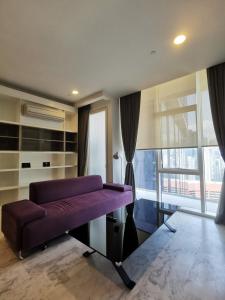 a purple couch in a room with a large window at The Platinum KLCC in Kuala Lumpur