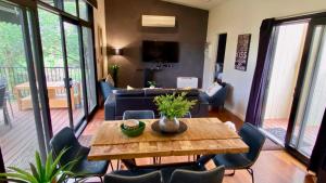 a living room with a table and chairs at The Nature Resort Villas in Cowes