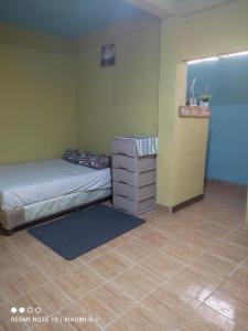 a bedroom with a bed and a dresser in it at IsmaRoom in El Remate