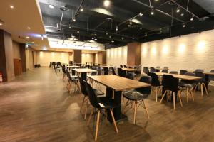 a large room with tables and chairs in it at Chance Hotel in Taichung