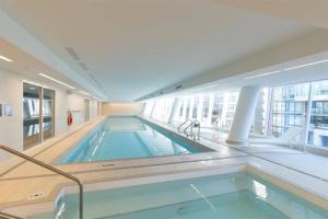 a large indoor swimming pool in a building at Zero Waste NEW Luxury Studio-AC/pool/hottub/gym in Vancouver