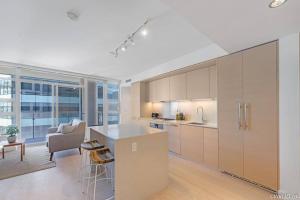 a kitchen with a counter and a kitchen island in a room at Zero Waste NEW Luxury Studio-AC/pool/hottub/gym in Vancouver