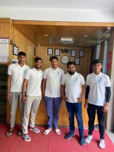 a group of men standing in front of a room at Hotel Seven Hills Manali in Manāli