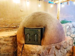 a stone oven with a clock on it at Yuyay Wasi Bungalows in Urubamba