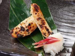 a plate of food with fish and rice on a banana leaf at APA Hotel Higashi Umeda Minami Morimachi Ekimae in Osaka