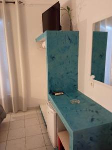 a kitchen with a blue counter top in a room at Hotel Theoxenia in Argos