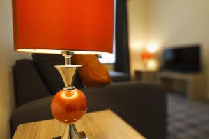 an orange lamp sitting on a table in a living room at Printworks in Peterhead