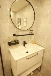 a bathroom with a white sink and a mirror at Borkum in Dorum-Neufeld