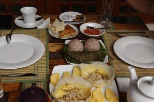 a table with plates of food on it at Blue Birds Tissa & Yala safari in Tissamaharama