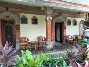 a patio with chairs and a table on a house at Hotel Grand Kumala Bali in Legian