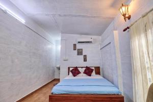 a bedroom with a bed in a white room at Waves and Shores Beach Villa in Mararikulam +30 photos