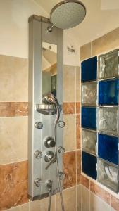 a shower with a shower head in a bathroom at Joy View in Kavála