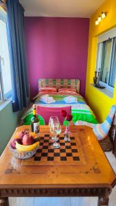 a room with a table with a chessboard and a bed at Joy View in Kavála