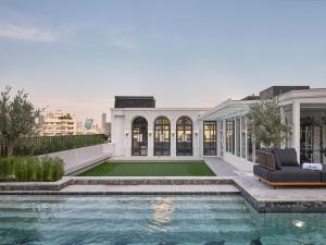an exterior view of a house with a swimming pool at The Alberti Hotel - Sukhumvit 31 in Bangkok