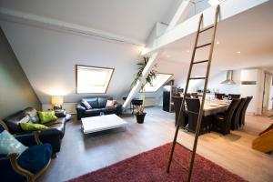 a living room with a ladder and a dining room at BIG MAMA with Aircon ,free parking in Colmar
