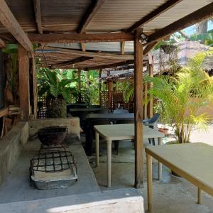 een patio met een grill, een tafel en een bank bij Two crazy monkeys in Bakjawan