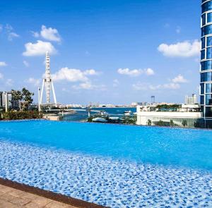a large blue swimming pool on top of a building at MarinaVista Bluewaters Island 52 42 Dubai Marina 2 BR-Beach-Sea View in Dubai