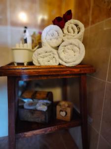 a pile of towels on a shelf in a bathroom at Joy View in Kavála