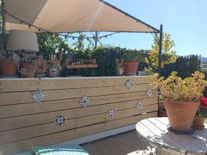 a patio with a table and an umbrella at Good Morning Etna in Bronte