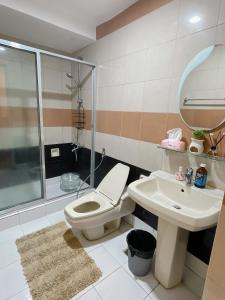 a bathroom with a toilet and a sink at Pearl Of The Orient Tower, in front of US Embassy in Manila