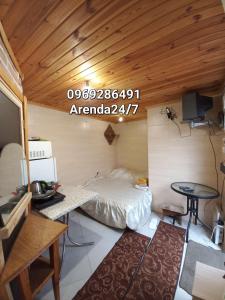 a small room with a bed and a table in it at Дом с удобствами in Cherkasy