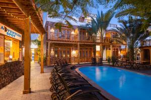 a resort with a swimming pool and chairs at The Bridge Dahab in Dahab
