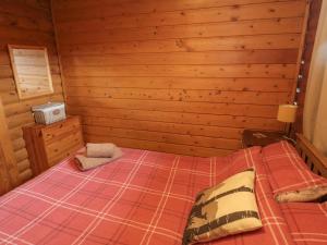 a bedroom with a bed in a wooden cabin at Glanton in Morpeth